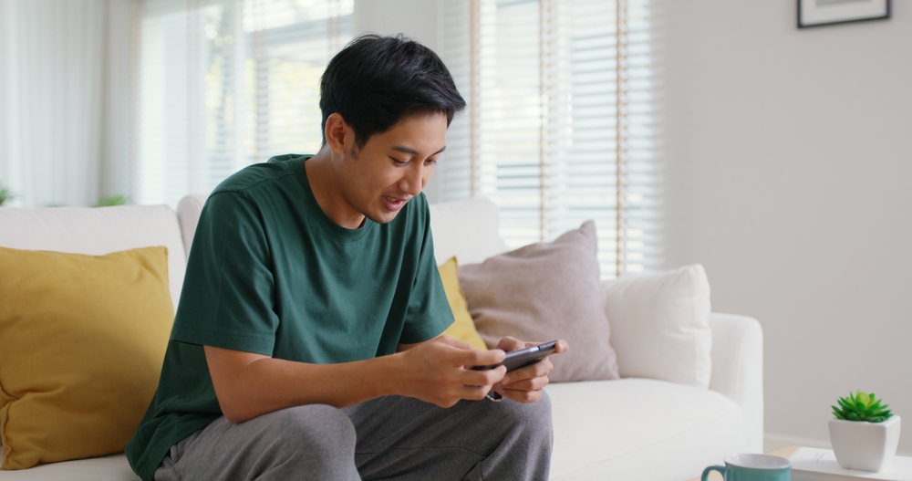man playing mobile phone