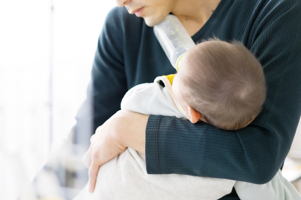 man feeding baby
